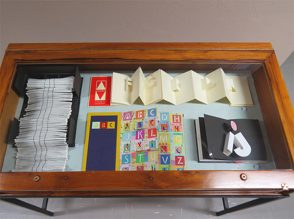 Click the image for a view of: Cabinet including Ronald King’s Alphabeta Concertina & Hedi Kyle's A to Z